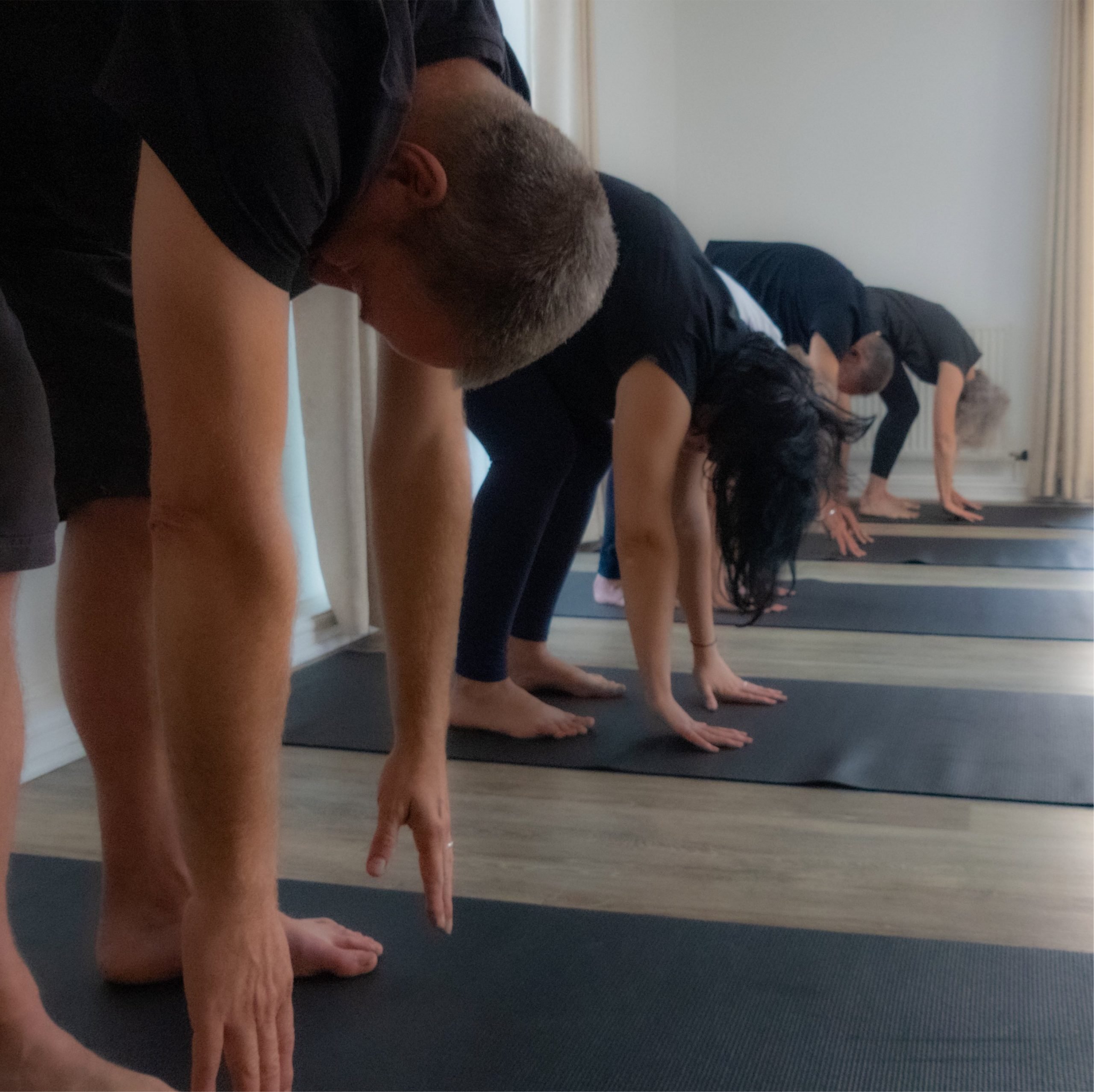 Yoga class standing forward bend
